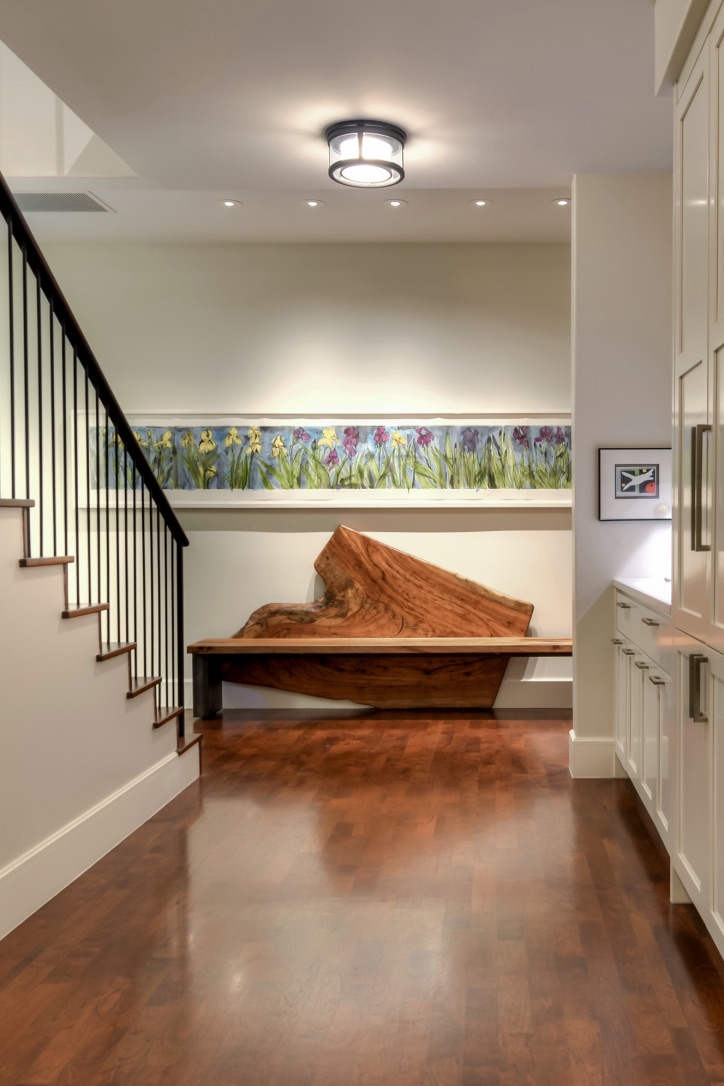 Luxury custom home interior with custom woodwork, staircase, built-in cabinetry, and curated architectural details