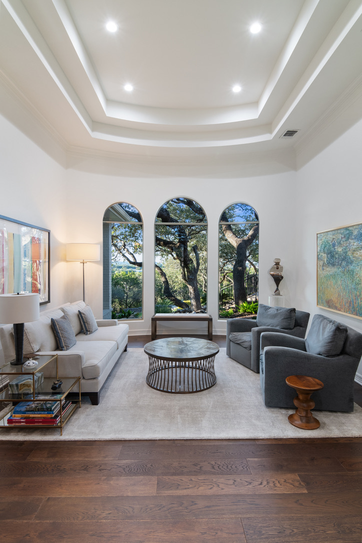 Luxury custom home living room with arched windows and thoughtfully coordinated interior finishes