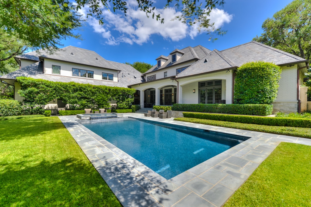 Luxury custom home with landscaped backyard and swimming pool
