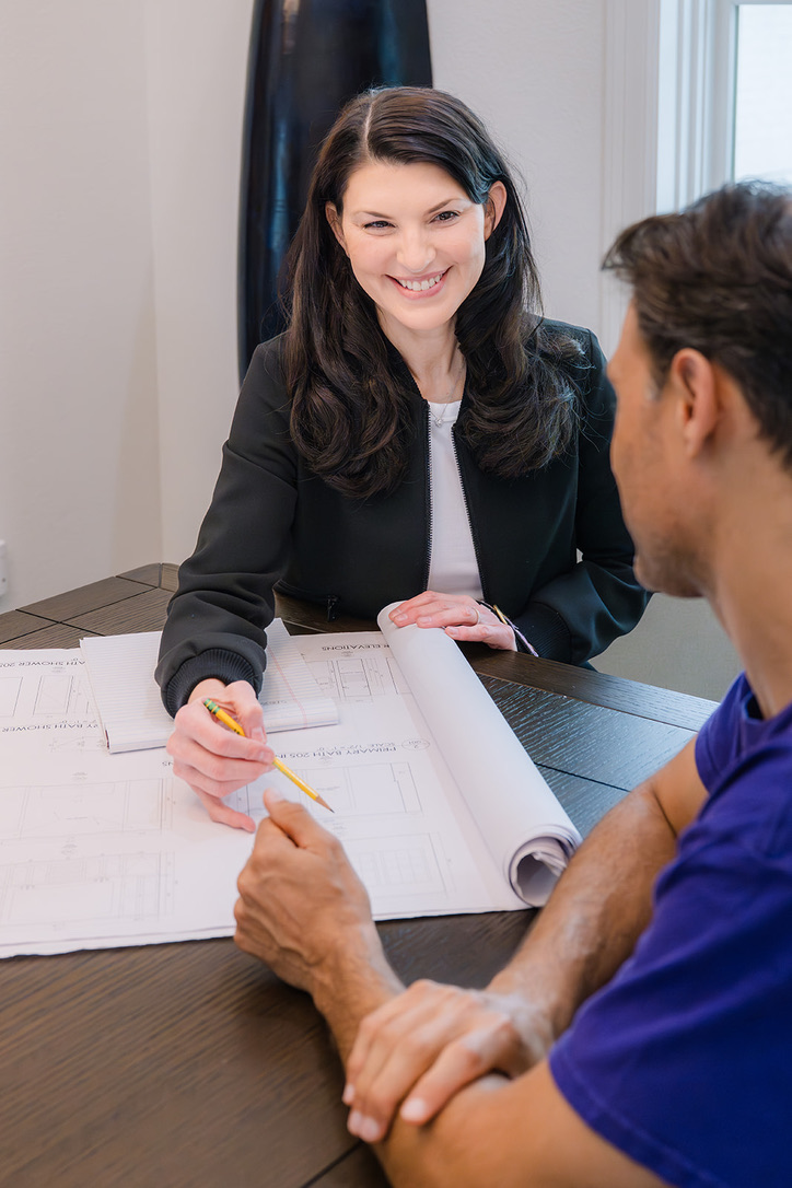 representative-reviewing-home-plans.jpg Residential owner's representative reviewing custom home plans with a client